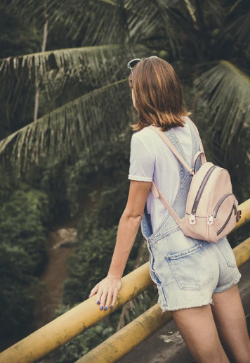 Young girl carrying pink backpack full of type one diabetes supplies