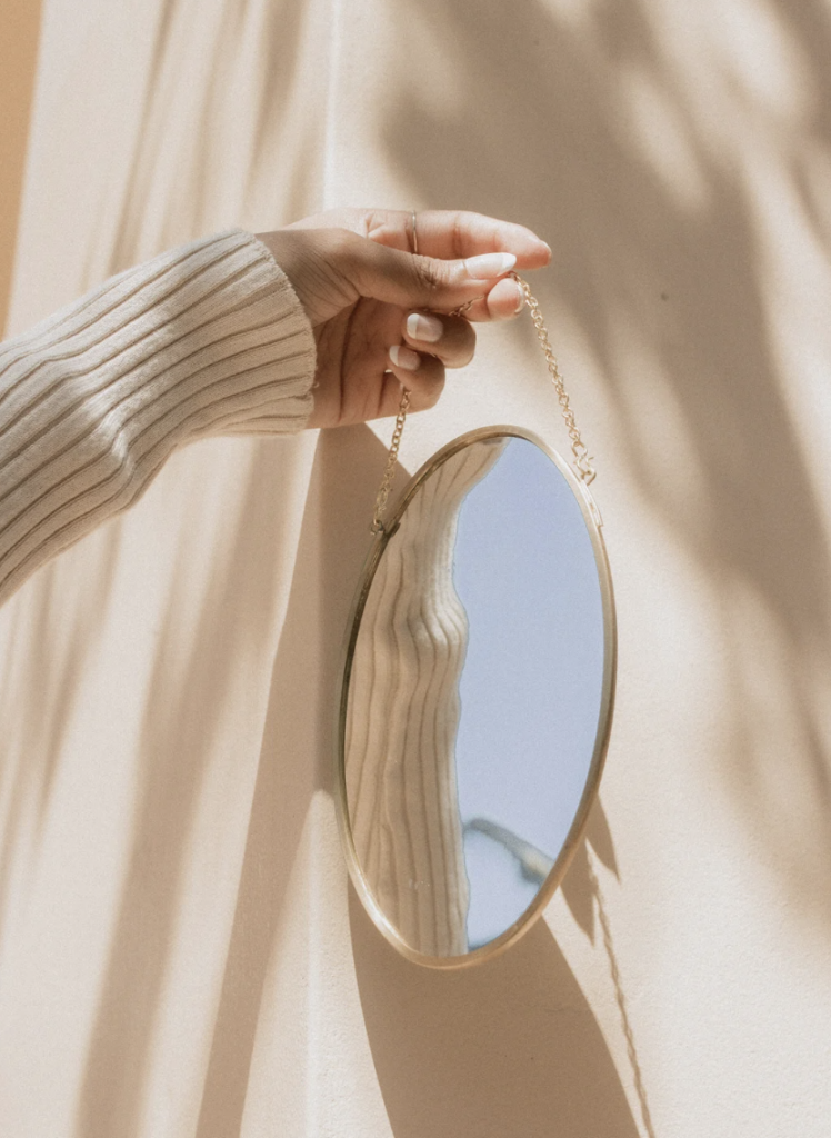 Woman holding up a mirror