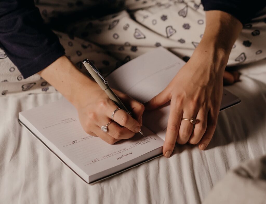 Woman writing in journal at night