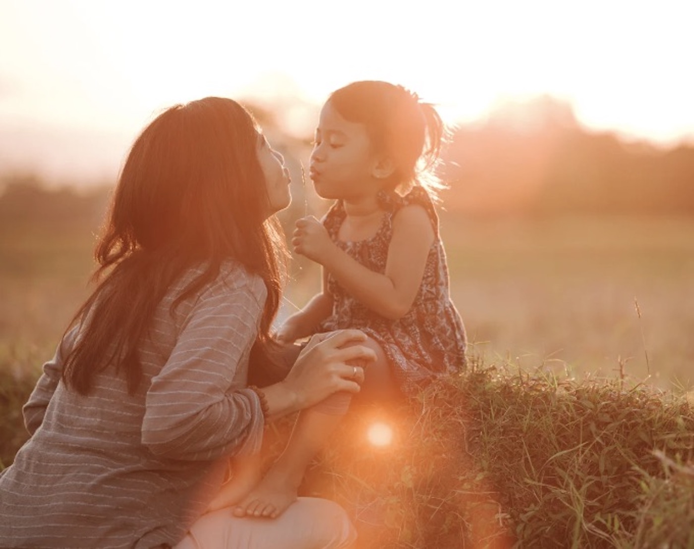 Young mother kissing daughter