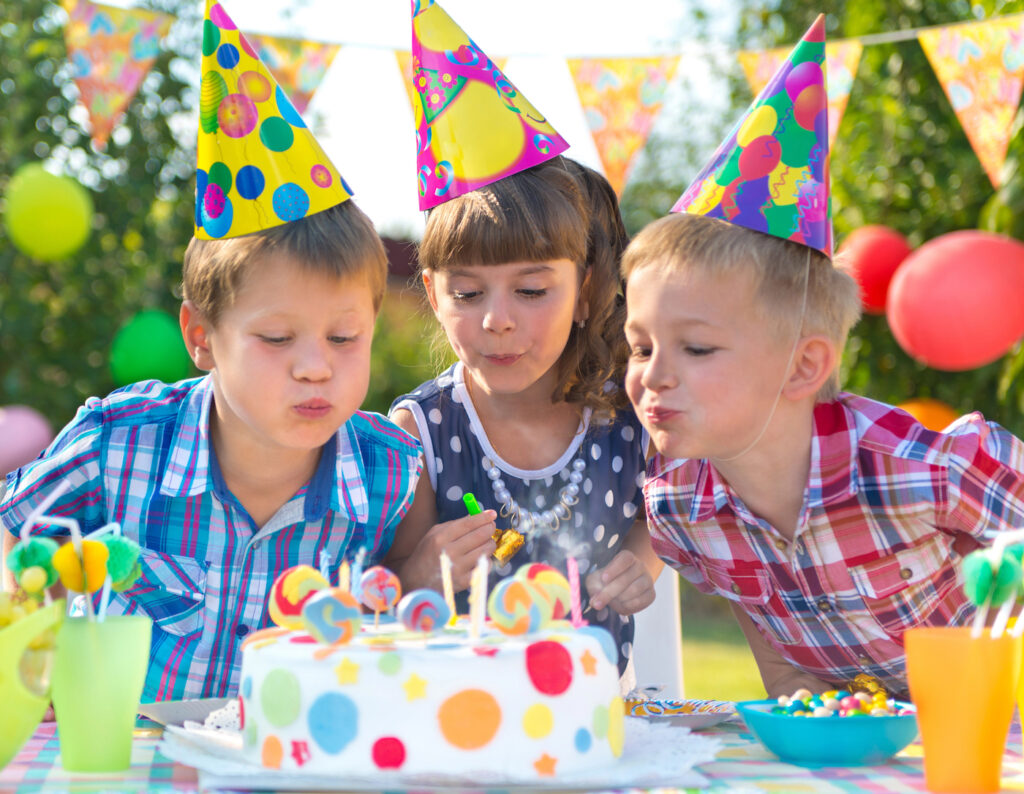 Type 1 diabetes children at birthday party blowing on birthday cake