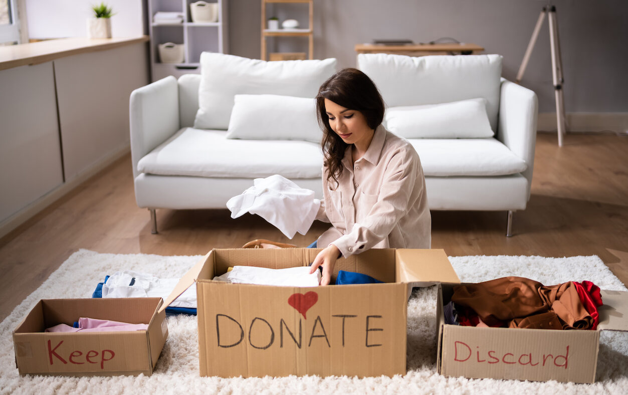 Type 1 diabetes caregiver sitting in living room placing items in boxes