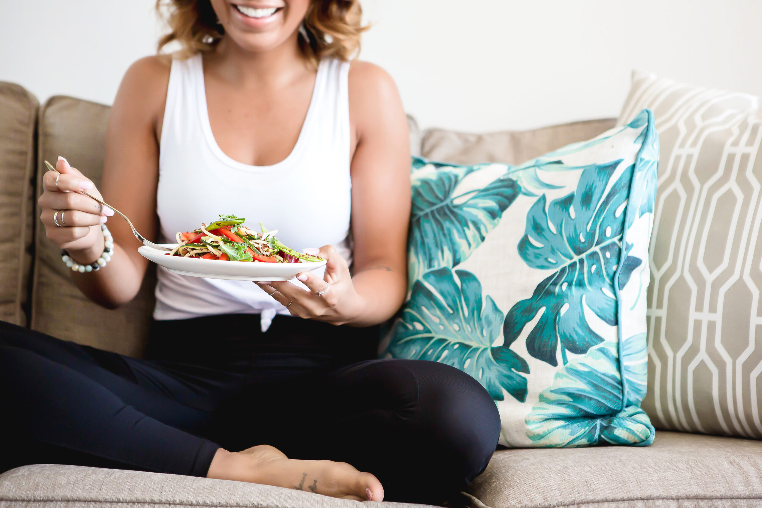 type 1 diabetes mom sitting down on couch eating a healthy salad for a healthier T1D family