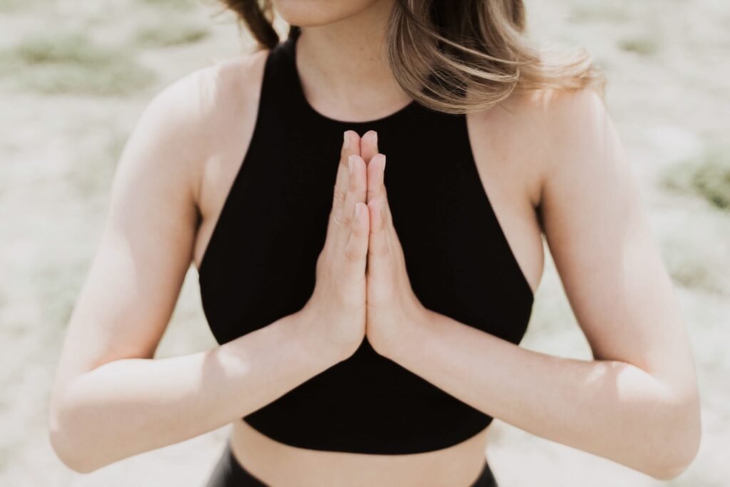 A mom placing her hands in prayer position over her heart, representing calm strategies for busy T1D moms managing daily life.